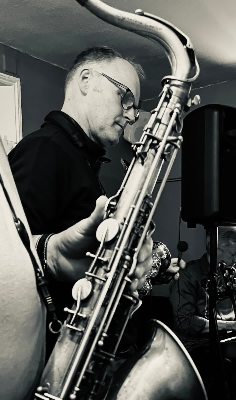 Andy on sax, framed within another sax